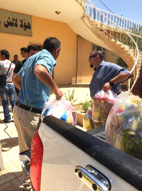 Handing out groceries to the persecuted Christians in Iraq.